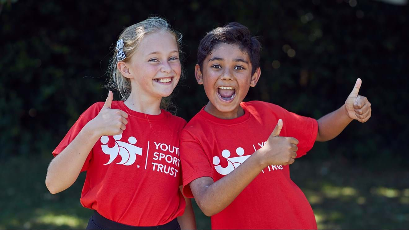 Two young people with thumbs up