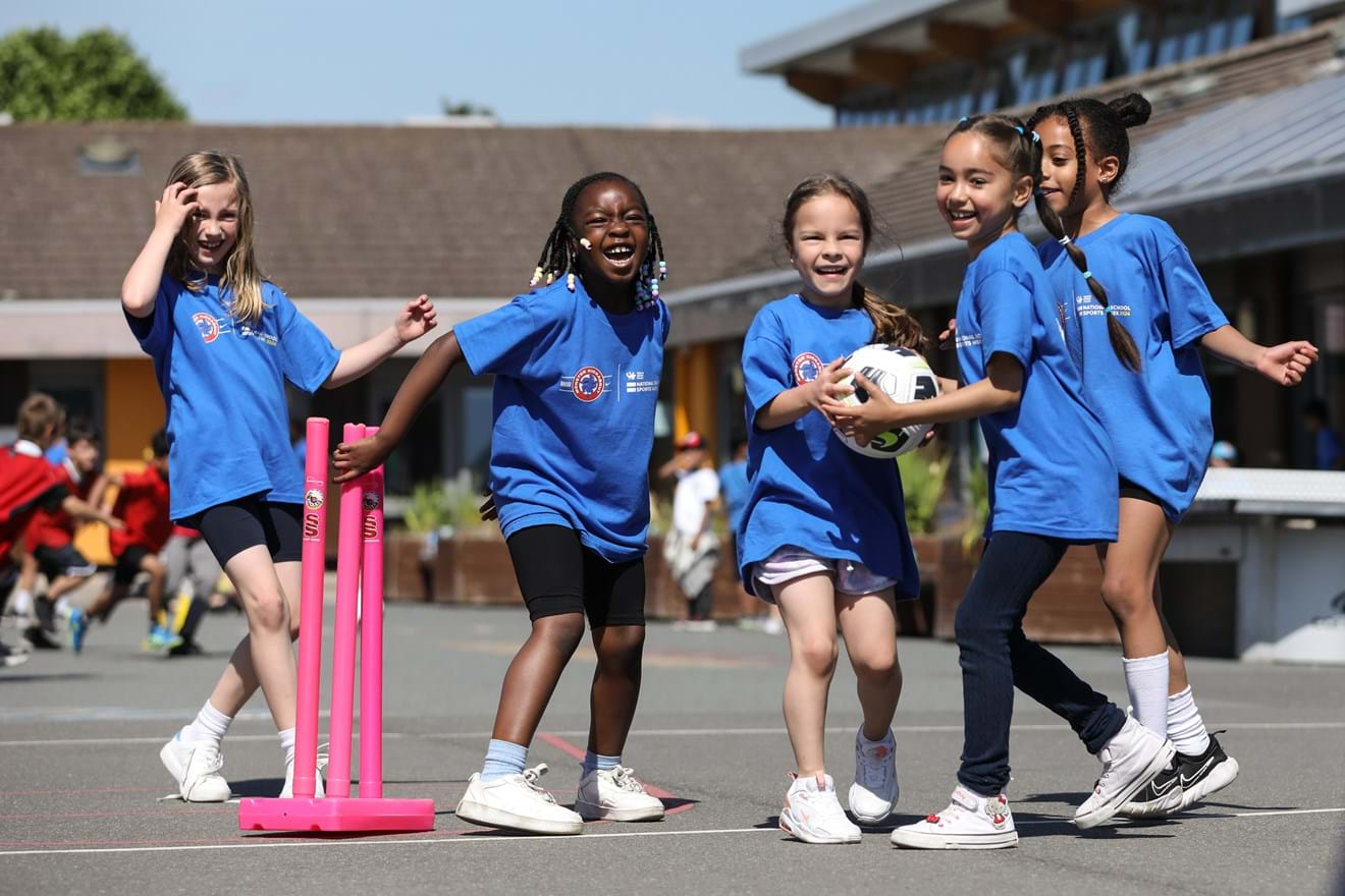 Group of girls laughing and playing football