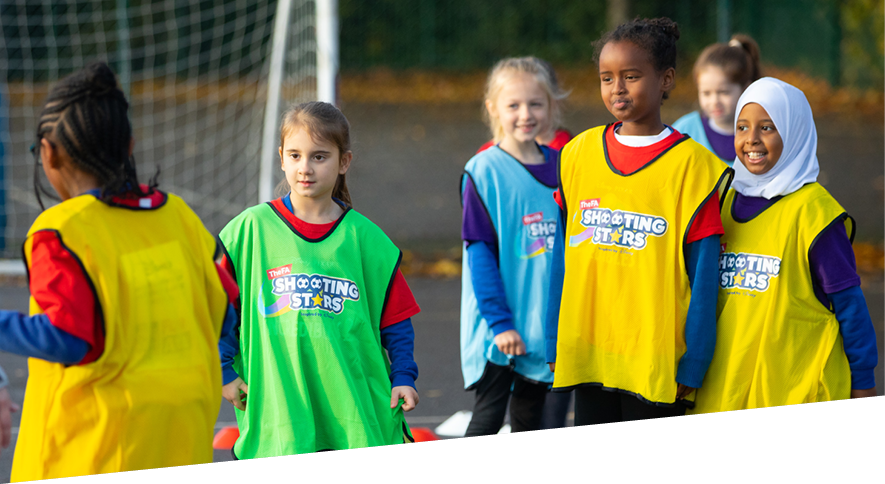 Group of girls taking part in  Shooting Stars girls' football programme